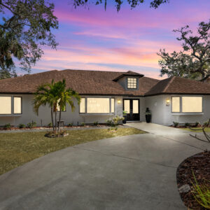 before Day to twilight conversion of a ranch-style home with curved driveway and palm trees